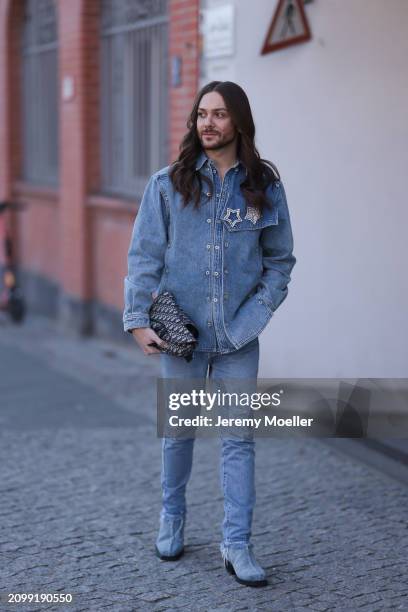 Riccardo Simonetti seen wearing Y Project blue denim jacket with rhinestone pattern star brooches, Levi’s blue denim straight leg pants / jeans,...