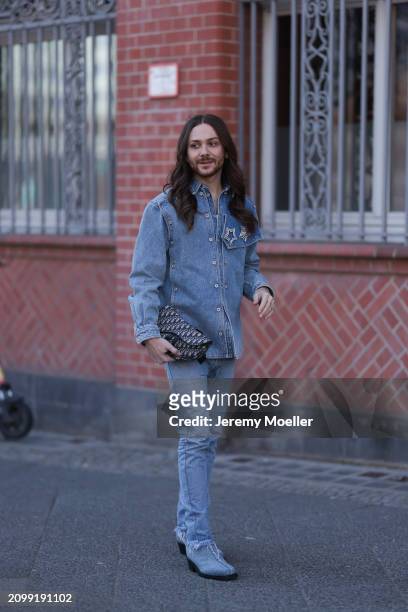 Riccardo Simonetti seen wearing Y Project blue denim jacket with rhinestone pattern star brooches, Levi’s blue denim straight leg pants / jeans,...