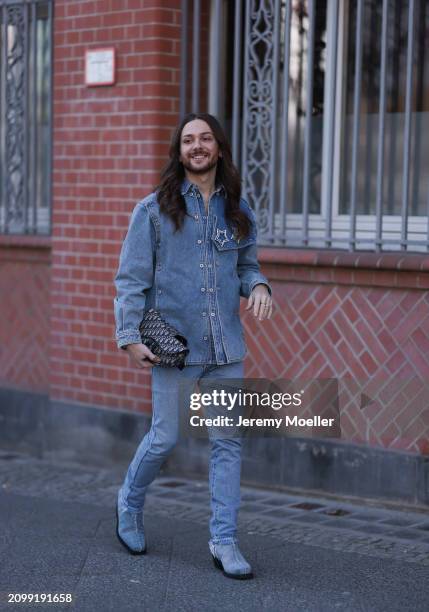 Riccardo Simonetti seen wearing Y Project blue denim jacket with rhinestone pattern star brooches, Levi’s blue denim straight leg pants / jeans,...