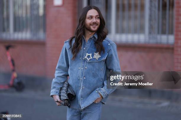 Riccardo Simonetti seen wearing gold sunglasses with blue lenses, Y Project blue denim jacket with rhinestone pattern star shaped brooches, Levi’s...