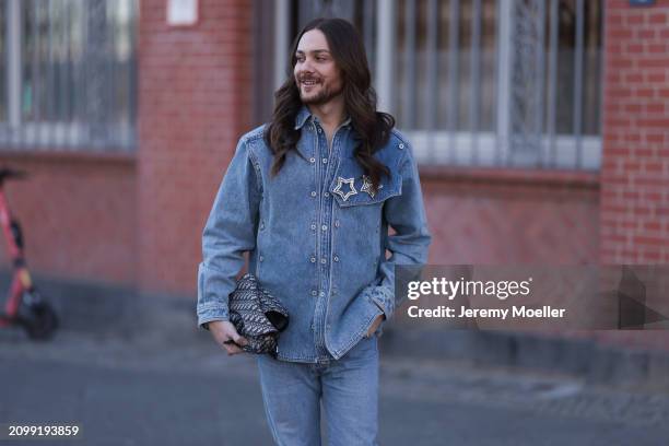 Riccardo Simonetti seen wearing gold sunglasses with blue lenses, Y Project blue denim jacket with rhinestone pattern star shaped brooches, Levi’s...