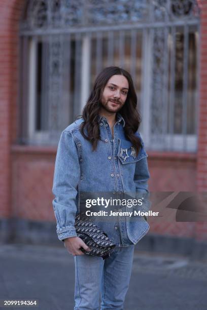 Riccardo Simonetti seen wearing gold sunglasses with blue lenses, Y Project blue denim jacket with rhinestone pattern star shaped brooches, Levi’s...