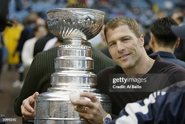 Defenseman Scott Stevens of the New Jersey Devils poses for a picture with the Stanley Cup before the interleague game between the New York Yankees...