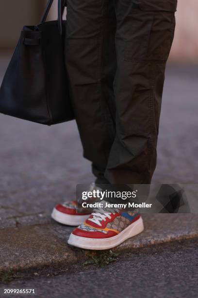 Riccardo Simonetti seen wearing Carhartt dark green cargo pants, Hermès Birkin 40 black leather bag and Gucci colorful / logo pattern sneakers, on...