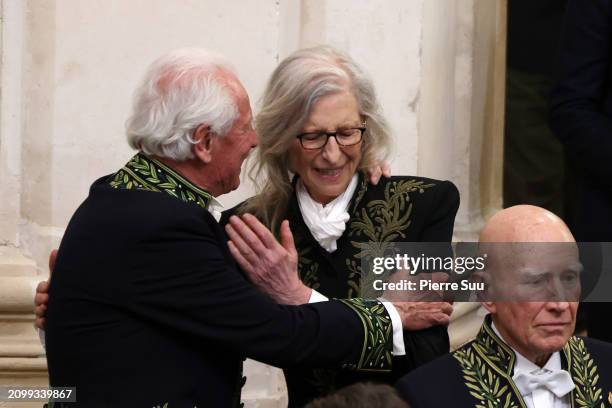 Yann Arthus-Bertrand embraces Annie Leibovitz during her intake ceremony into the Académie des Beaux-Arts on March 20, 2024 in Paris, France.The...