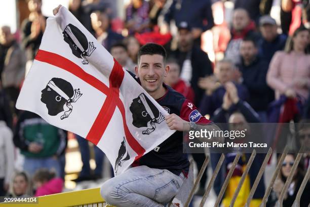 Supporters of Cagliari Calcio shows the flag of 'quattro mori' during the Serie A TIM match between AC Monza and Cagliari at U-Power Stadium on March...