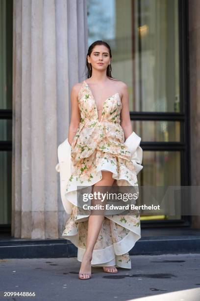 Valentina Ferragni wears a sleeveless asymmetric ruffled floral dress with a deep neckline, high heeled sandals, outside Zimmermann, during the...