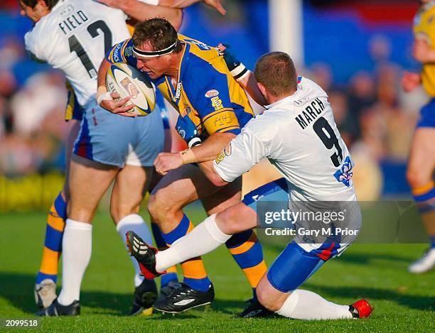 David Furner of Leeds is tackled by David March of Wakefield during the Tetleys Bitter Super League match between Wakefield Trinity Wildcats and...