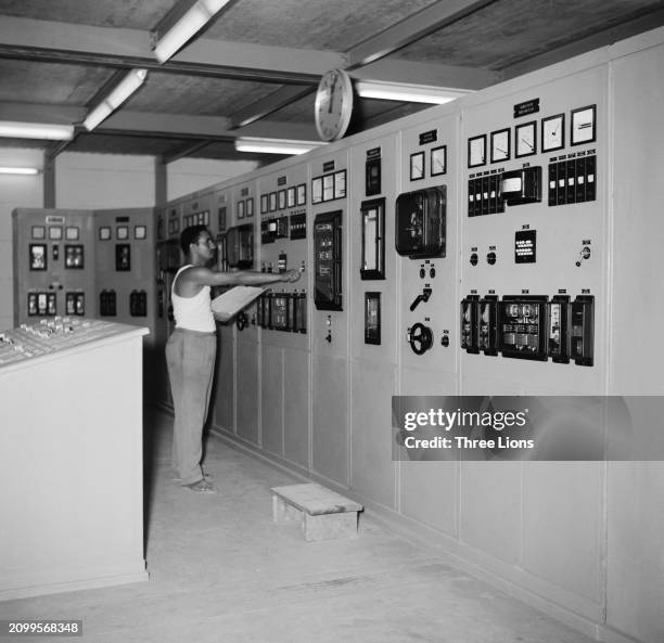 Staff at work with the switch and instrument board in the electrical power station at the Royal State Palace, Jeddah, Saudi Arabia, circa 1955.