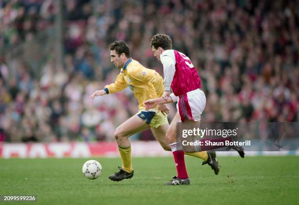 Leeds United striker Eric Cantona races past the challenge of Arsenal defender David O' Leary during a First Division match at Highbury on March 22nd...