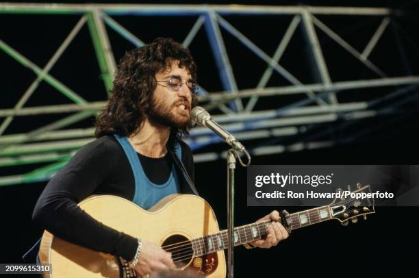 South African singer and musician John Kongos performs with acoustic guitar on the set of a pop music television show in London in 1971.