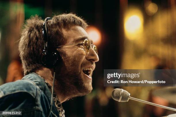 English musician John Lennon of The Beatles and the Plastic Ono Band performing the song 'Instant Karma' on the set of a pop music television show in...