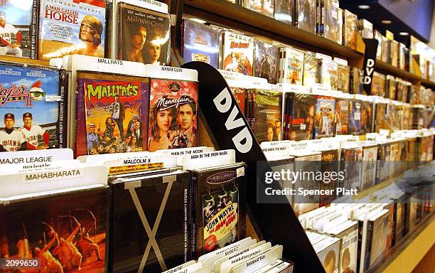 DVDs sit on a shelf June 20, 2003 in New York City. For the first time last week, weekly rentals of DVDs surpassed VHS videos. According to the trade...