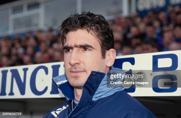 Substitute Leeds United forward Eric Cantona looks on from the bench prior to making his Leeds debut during the League Division One match between...