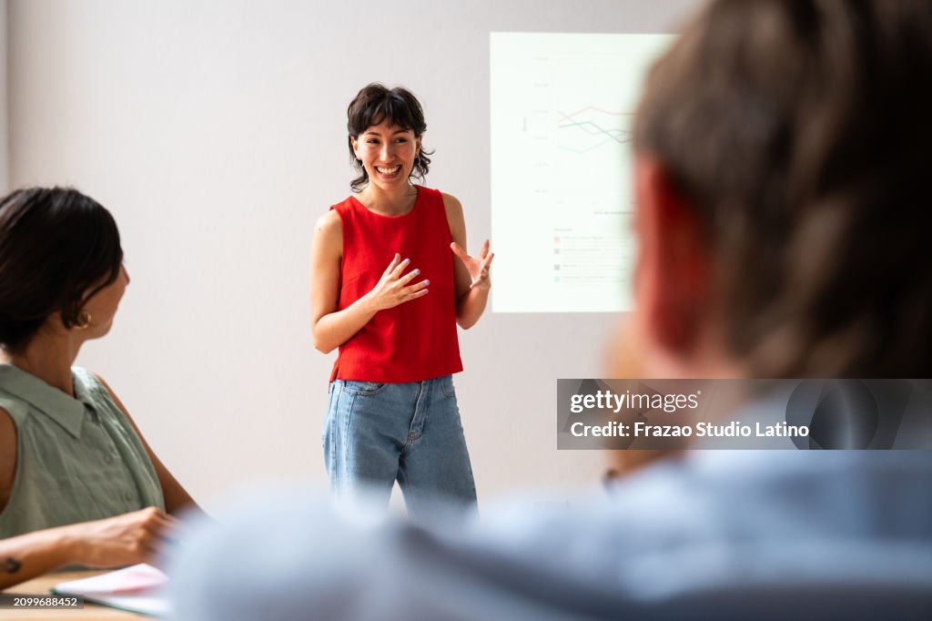 Young woman making a presentation in the meeting room