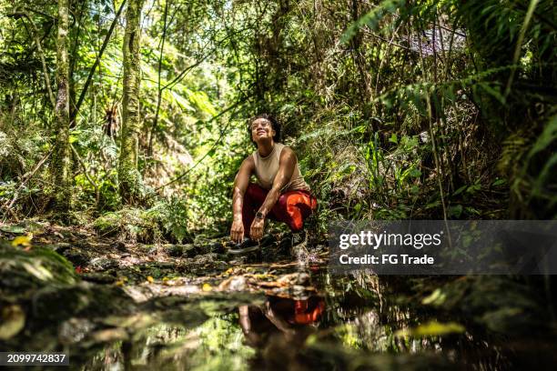 young woman looking up during hiking on forest - south america stock pictures, royalty-free photos & images