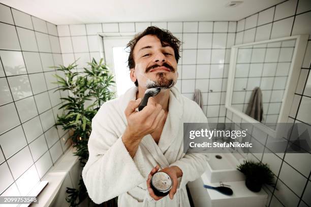 man applies shaving cream - shaving stock pictures, royalty-free photos & images