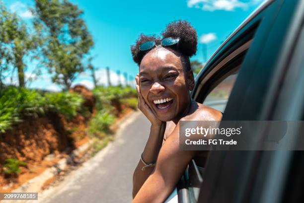 portrait of a young woman traveling by car - excitement stock pictures, royalty-free photos & images