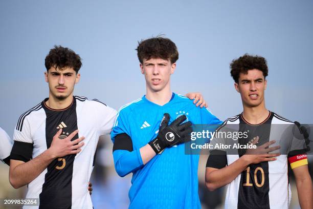 Maxim Dal, Timo Schlieck and Noah Darvich of U18 Germany reacts at the national anthem during the Under 18 Nations Tournament match between...