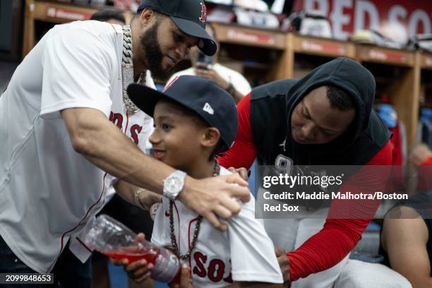 Rafael Devers of the Boston Red Sox signs the jersey of El Alfa in the clubhouse before a 2024 Dominican Republic Series game against the Tampa Bay...