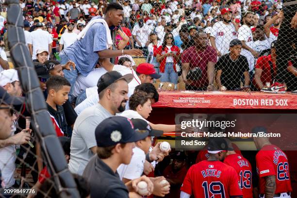 Fans reacts as Boston Red Sox players walk into the clubhouse after winning a 2024 Dominican Republic Series game against the Tampa Bay Rays as part...