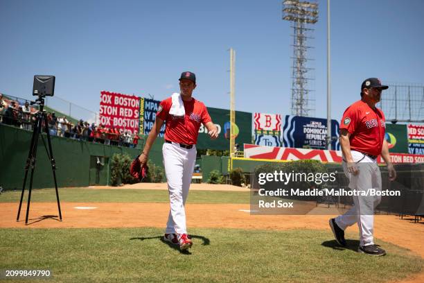 Garrett Whitlock of the Boston Red Sox walks out of the bullpen with Game Planning Coordinator and Catching Coach Jason Varitek of the Boston Red Sox...