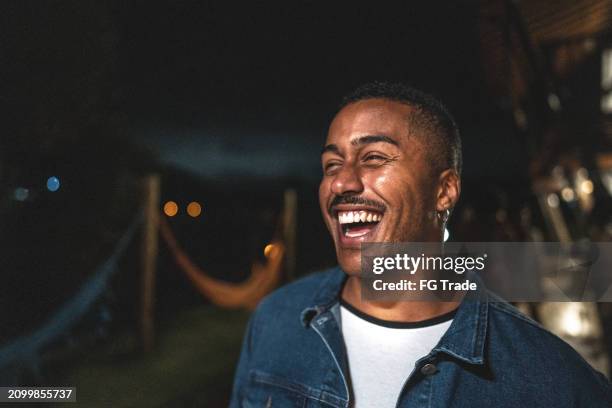 happy young man on a house yard at night - party atmosphere stock pictures, royalty-free photos & images