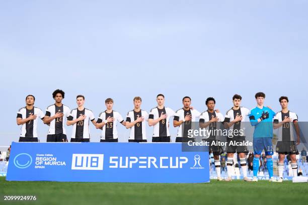 Players of U18 Germany participate in the German national anthem prior to the Under 18 Nations Tournament match between Netherlands v U18 Germany on...