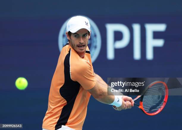 Andy Murray of Great Britain returns a shot against Matteo Berrenttini of Italy during their match on Day 5 of the Miami Open at Hard Rock Stadium on...