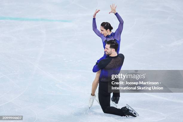 Deanna Stellato-Dudek and Maxime Deschamps of Canada compete in the Pairs Short Program during the ISU World Figure Skating Championships at Centre...