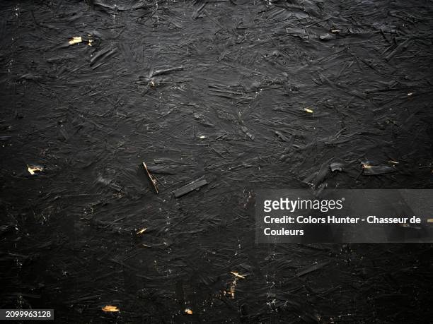 close-up of a textured wooden panel painted in black. photograph taken on a construction site in london, england, united kingdom. sunlight and shadow. natural colors. - retro style wood paneling stock pictures, royalty-free photos & images