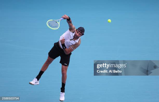 Matteo Berrenttini of Italy serves against Andy Murray of Great Britain during their match on Day 5 of the Miami Open at Hard Rock Stadium on March...