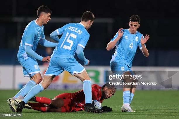 Harry Panayiotou of St. Kitts and Nevis clashes with Andrea Contadini, Marco Pasolini and Lorenzo Capicchioni of San Marino during the International...