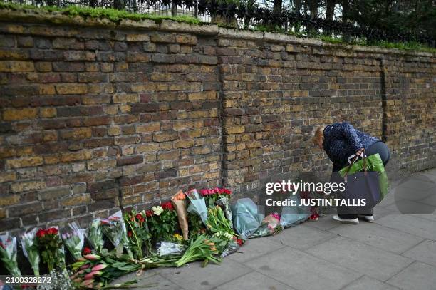 Person lays flowers outside the Russian embassy in London on March 23 a day after a gun attack in Krasnogorsk, outside Moscow. Camouflaged assailants...