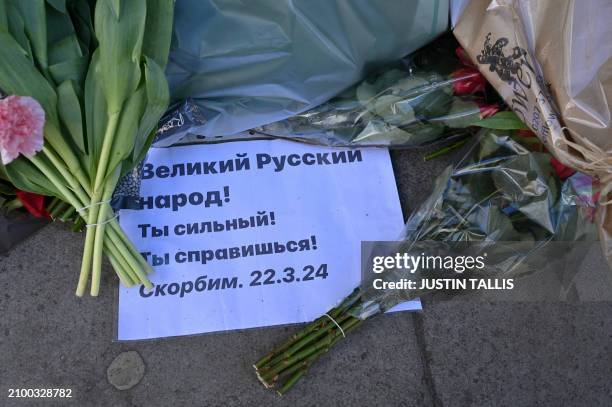 Flowers and tributes are pictured outside the Russian embassy in London on March 23 a day after a gun attack in Krasnogorsk, outside Moscow....