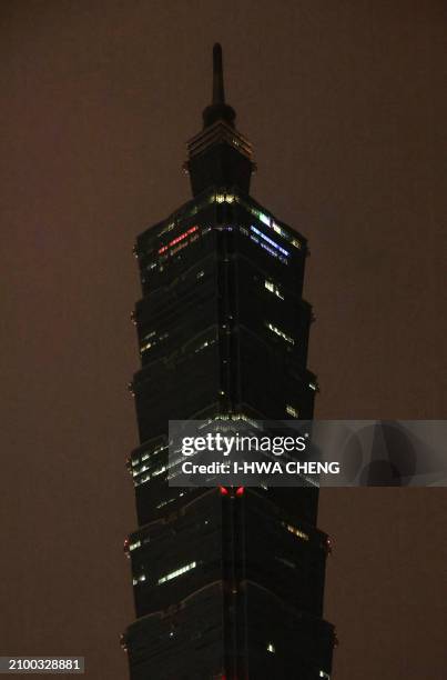 The landmark building Taipei 101 is seen with its lights switched off to mark the Earth Hour environmental campaign in Taipei on March 23, 2024.
