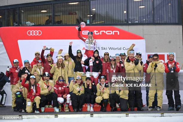 Austria's team celebrates with the Crystal Globe after winning the Women's Nations Cup of the FIS Alpine Skiing Women's World Cup in Saalbach,...