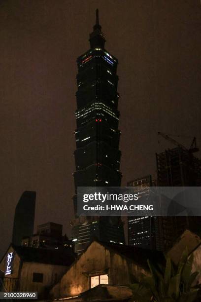 The landmark building Taipei 101 is seen with its lights switched off to mark the Earth Hour environmental campaign in Taipei on March 23, 2024.