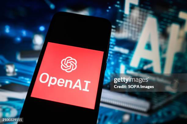 In this photo illustration a Open AI logo is displayed on a smartphone with Artificial Intelligence symbol on the background.