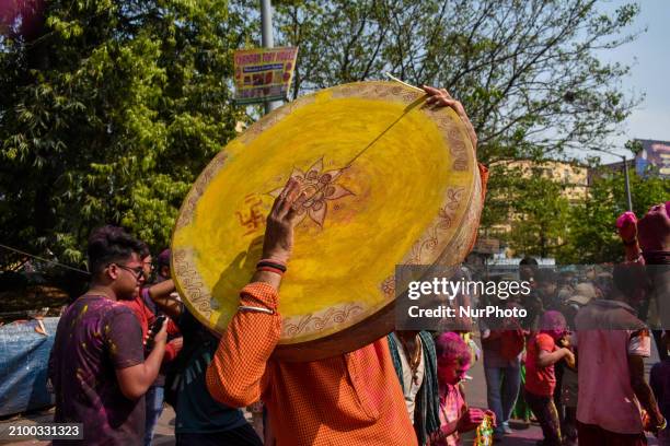 People are celebrating Holi with various musical instruments in the streets of Kolkata, India, on March 23, 2024. Holi, also known as the festival of...