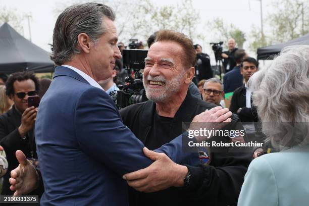 Los Angeles, CA, Friday, March 22, 2024 - California Governor Gavin Newsom embraces former Governor Arnold Schwarzenegger at a news conference hosted...