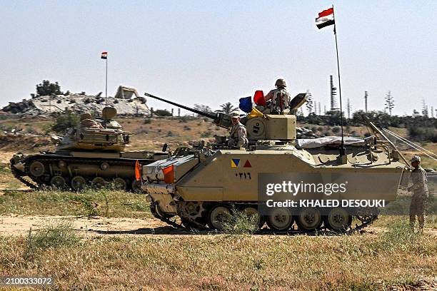 An Egyptian army M60 main battle tank and an infantry fighting vehicle are deployed near the Egyptian side of the Rafah border crossing with the Gaza...