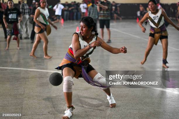 An indigenous woman kicks the ball during a Mayan ball game match in Tecpan, Guatemala on March 23, 2024. Dressed in shorts, girdle and uncovered...