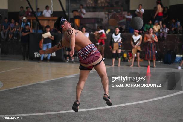 An indigenous man kicks the ball during a Mayan ball game match in Tecpan, Guatemala on March 23, 2024. Dressed in shorts, girdle and uncovered...