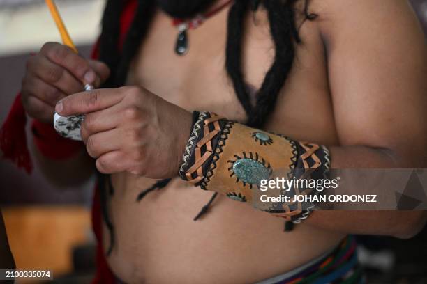 An Indigenous man prepares to play a Mayan ball game match in Tecpan, Guatemala on March 23, 2024. Dressed in shorts, girdle and uncovered torso,...
