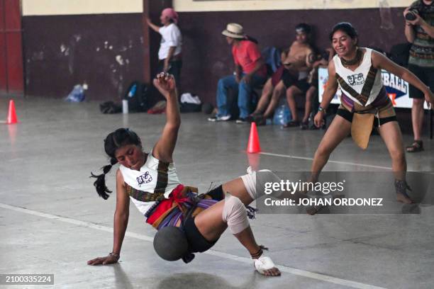 An indigenous woman kicks the ball during a Mayan ball game match in Tecpan, Guatemala on March 23, 2024. Dressed in shorts, girdle and uncovered...