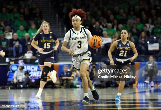 Hannah Hidalgo of the Notre Dame Fighting Irish dribbles the ball down the court in front of Bridget Dunn of the Kent State Golden Flashes and Dionna...