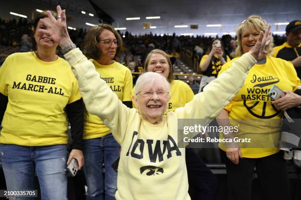 Dee Vanderhoef, an Iowa Hawkeyes fan and season ticket holder since the 1970s, cheers prior to tipoff against the Holy Cross Crusaders during the...