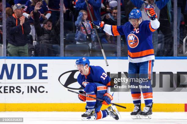 Mathew Barzal of the New York Islanders celebrates with Anders Lee after scoring a goal against the Winnipeg Jets during the second period at UBS...