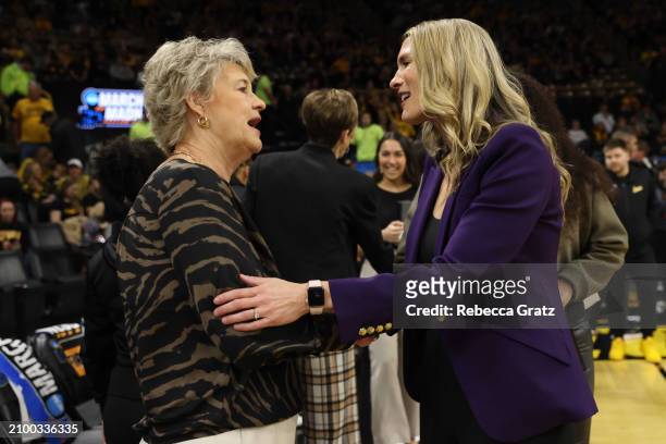Lisa Bluder, head coach of the Iowa Hawkeyes, left, greets Maureen Magarity, head coach of the Holy Cross Crusaders, prior to tipoff during the first...